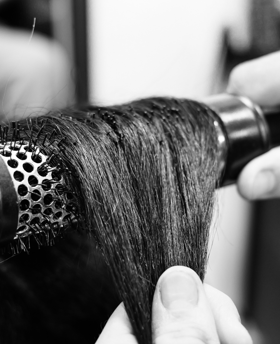 close up of black hair being brushed by hair stylist in The Style Lounge No.1 Sheffield
