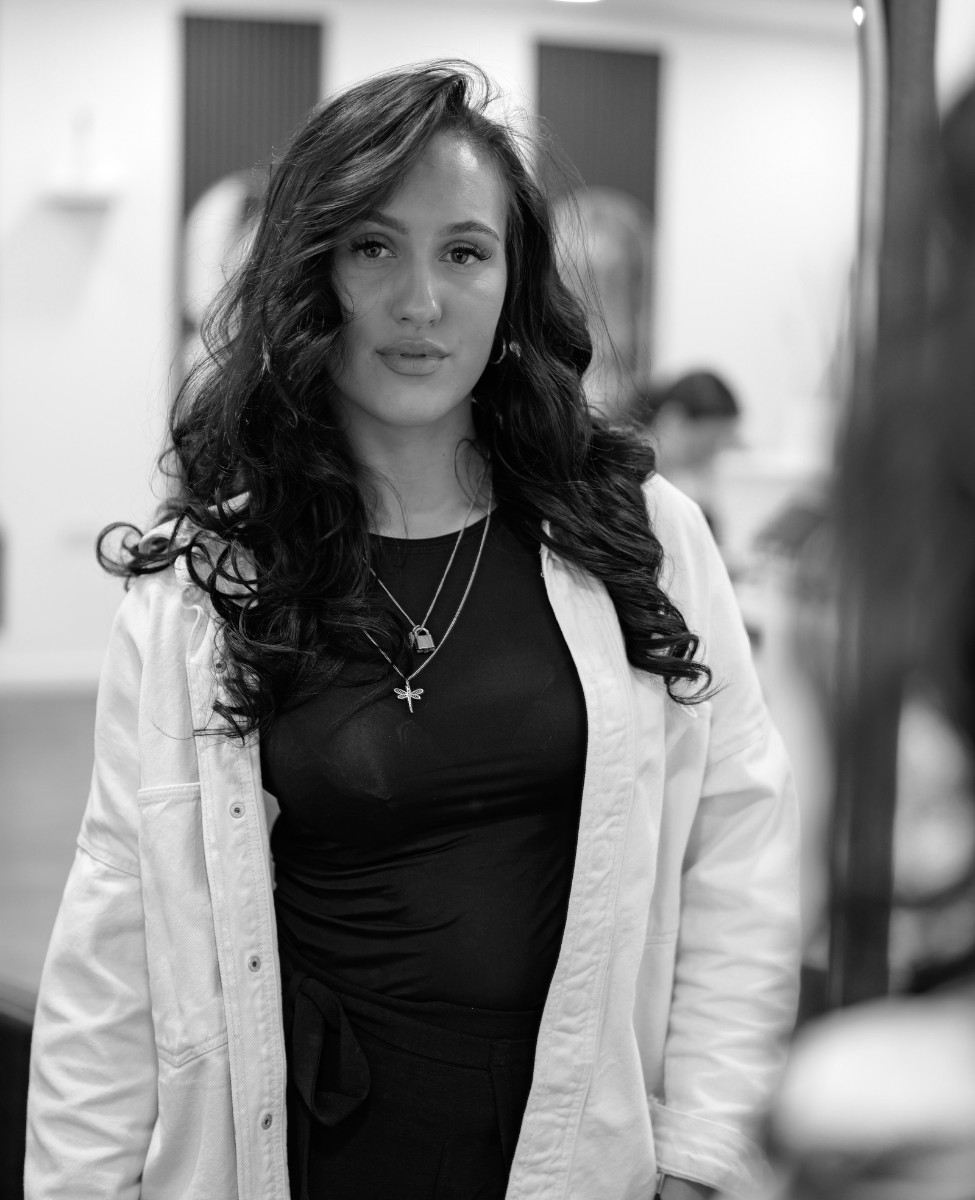 Black and White image of beautiful young woman with ling black wavy hair done in best hair salon in Sheffield, The Style Lounge No. 1